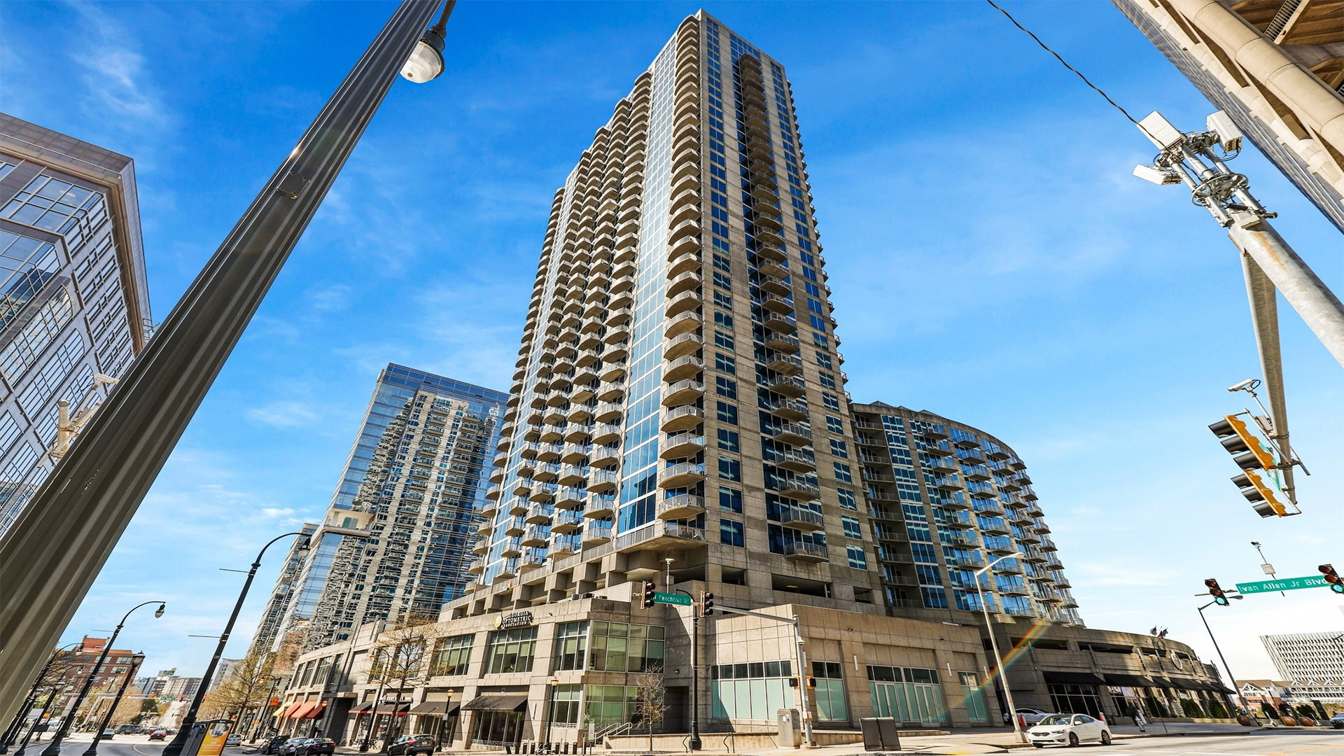 Secure and stylish apartment entry door with sleek wood finish, enhancing multi-unit residential access.