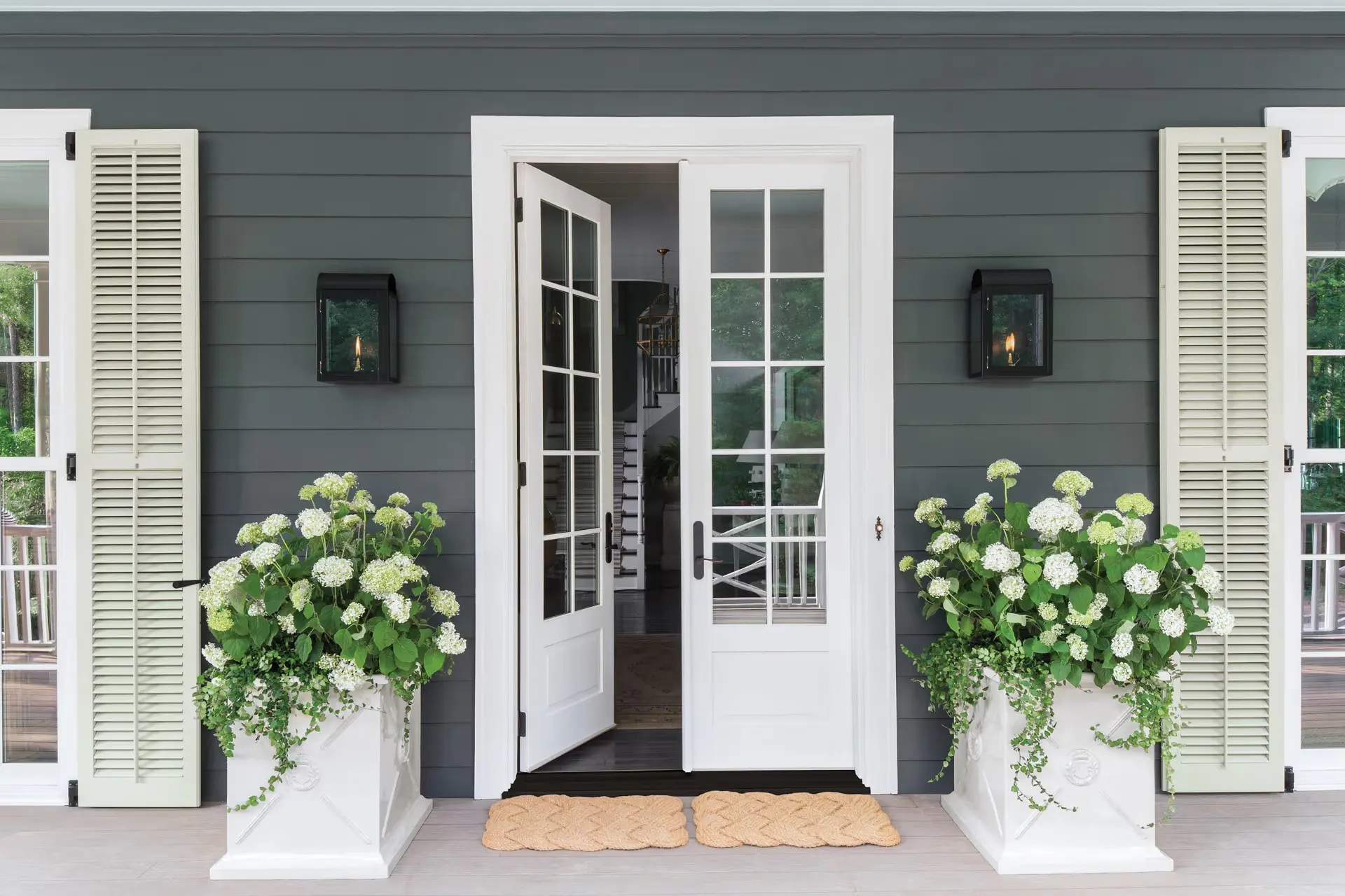 Sturdy exterior door with a peephole and side windows for added home security.