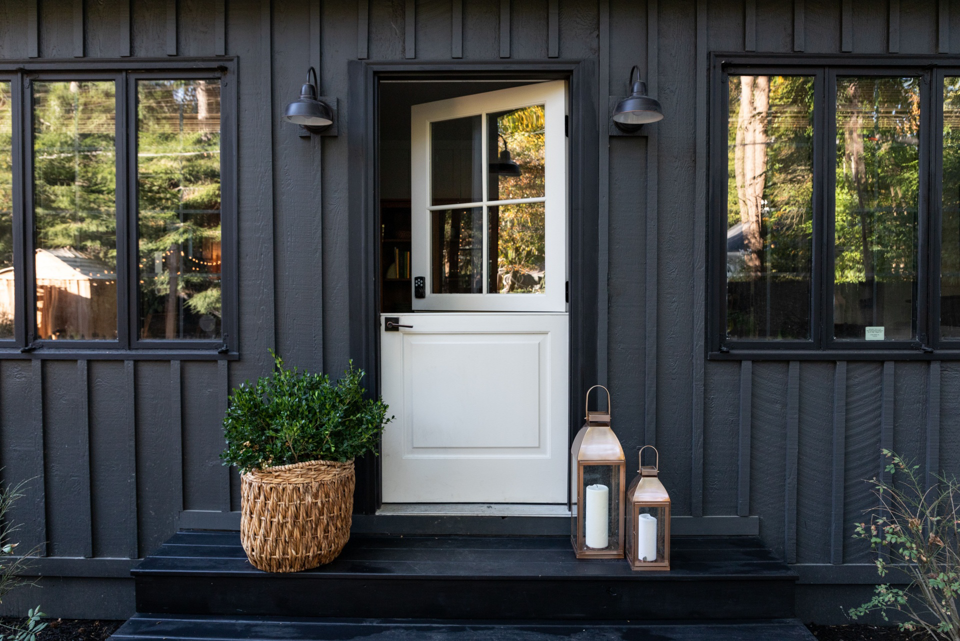 Modern black exterior door with glass panels enhancing curb appeal of a contemporary home.