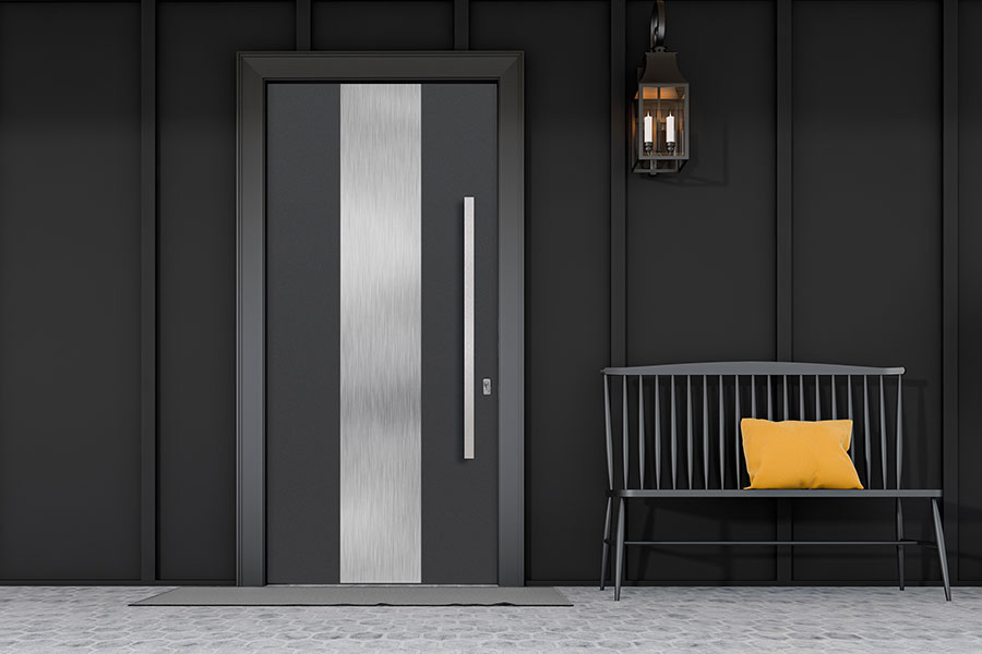 Custom entry door made of reclaimed wood and industrial steel accents.