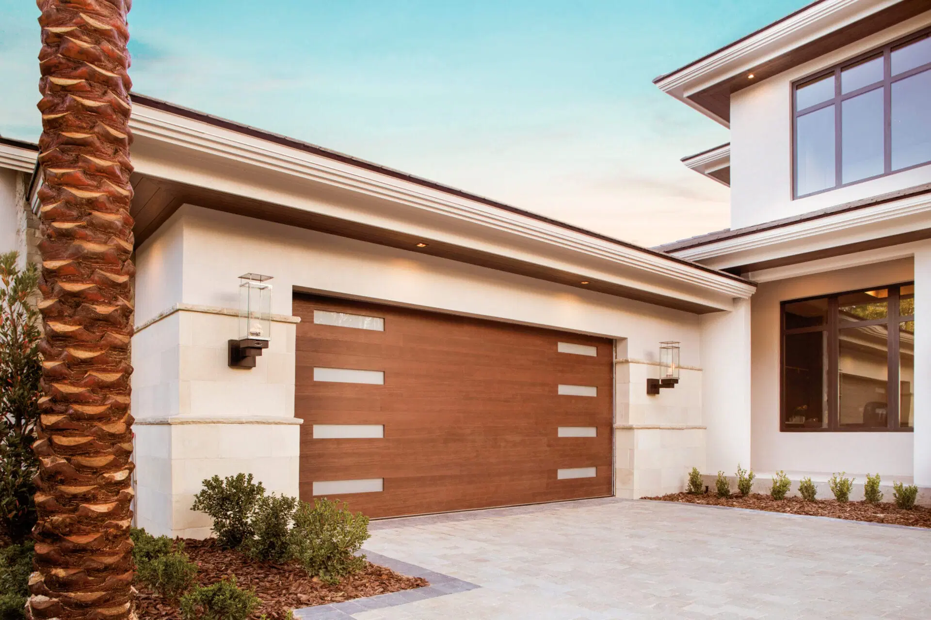 Luxury house exterior featuring a custom wooden garage door.
